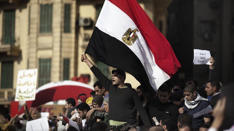 Egyptian demonstrators wave their national flag in Tahrir Square in central Cairo on January 30, 2011