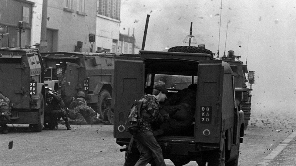 Soldiers taking shelter from a bomb explosion in Belfast