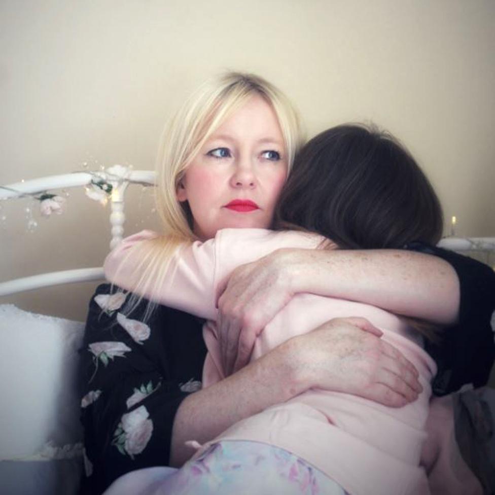 Tracy holds her daughter