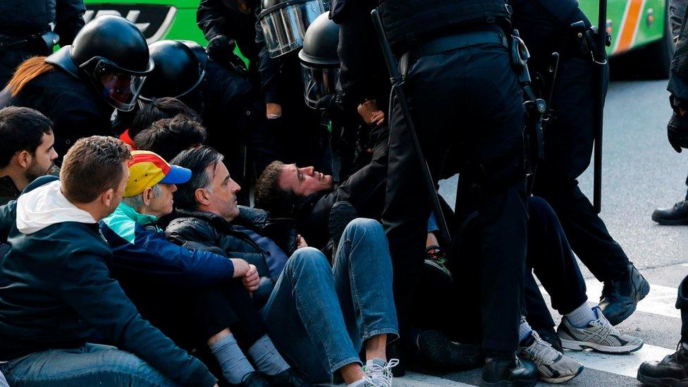 Catalan regional policemen (Mossos d"Esquadra) drag a picketer blocking the street at the North Bus Station in Barcelona