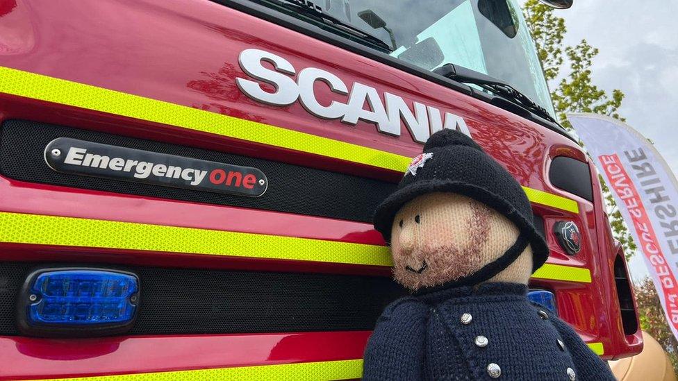 Knitted fireman on fire engine