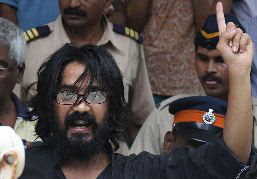 In this photograph taken on September 9, 2012, Indian cartoonist Aseem Trivedi gestures outside a court in Mumbai .