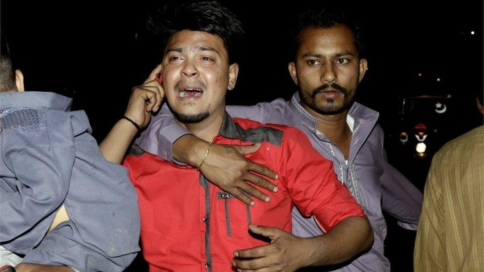 A man mourns his dead relative in Lahore, Pakistan