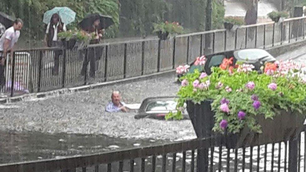 Handout photo taken with permission from the twitter feed of @Whatoninsutton and @discobabe of flooding in Wallington, Surrey