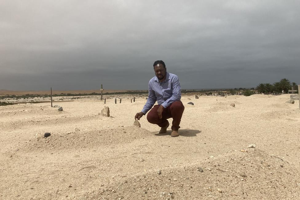 Laidlaw Peringanda at a mass grave of concentration camp victims