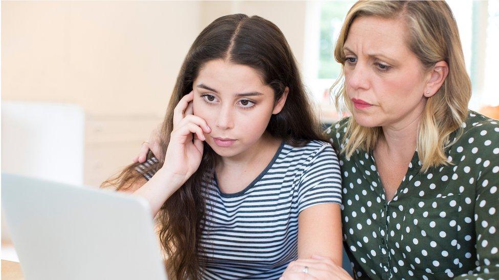 Mother-comforting-daughter-victimized-by-online-bullying.