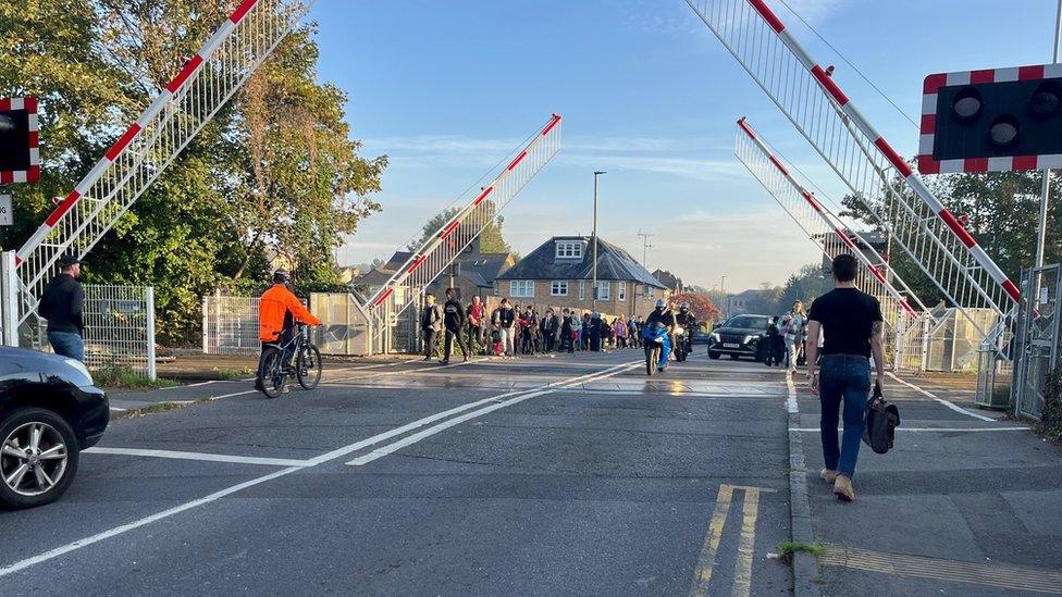 Pedestrians and motorists using the Egham crossing