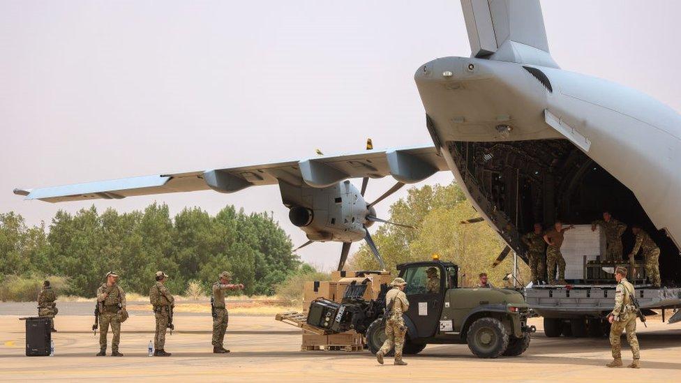 UK military personnel unloading stores for British nationals on Tuesday