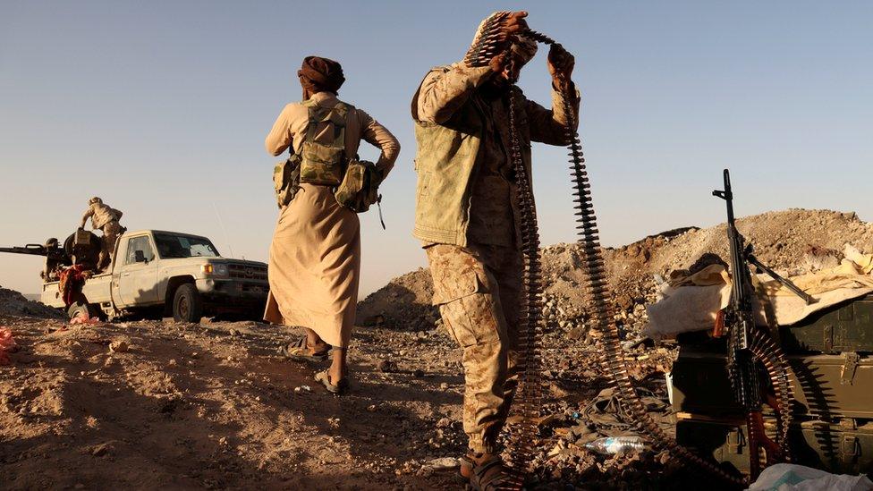 A Yemeni pro-government fighter holds a machine gun bullet belt at a frontline position during fighting against Houthi fighters in Marib, Yemen (16 March 2021)