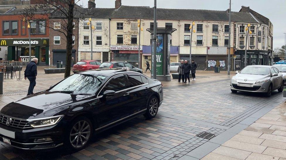 Cars parked on pedestrian street