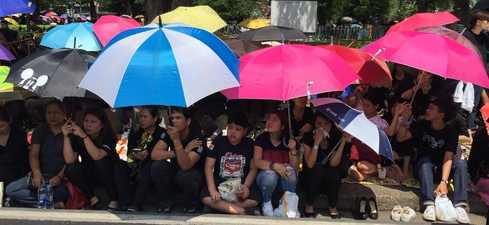 Mourners lining the streets of Bangkok awaiting the Thai King's funeral procession on 14 October 2016