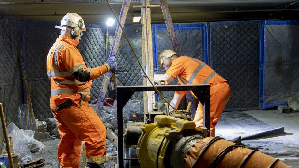 Workers digging a borehole under Palace of Westminster