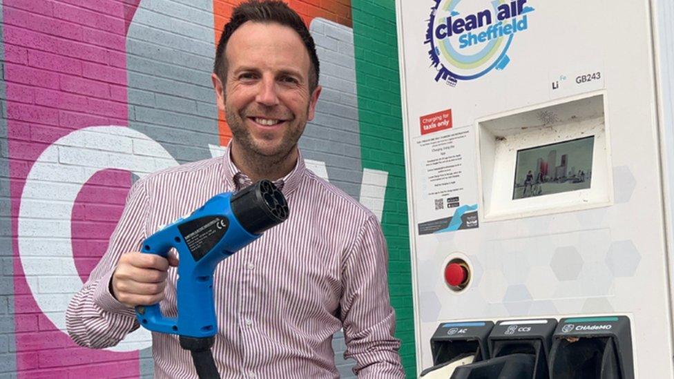 Man holding an EV charging cable