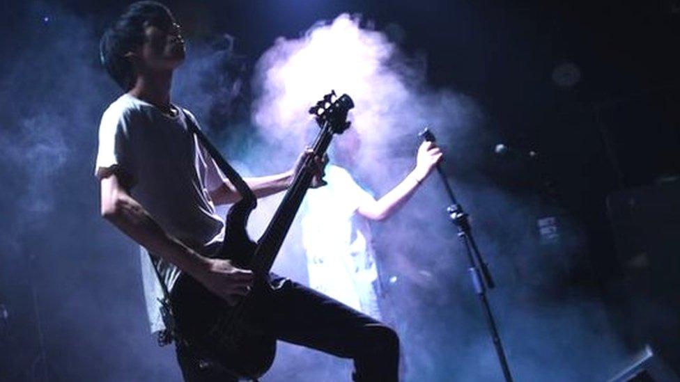 This photo taken on September 17, 2014 shows rock band Bu Ou performing in a bar in Beijing. Beijing has a vibrant rock scene with bands performing at small bars throughout the week.