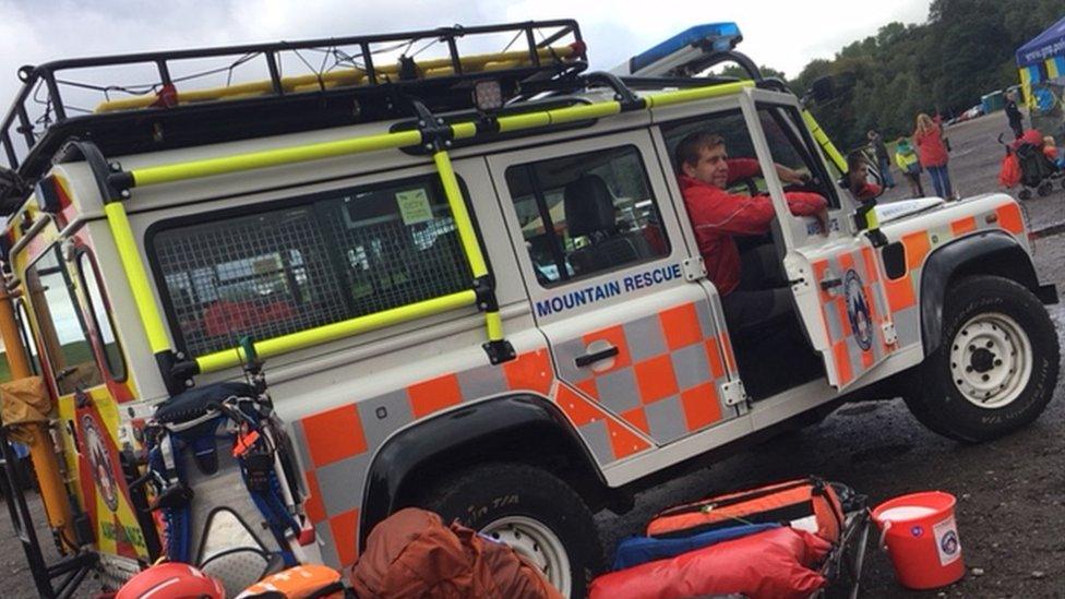 man in mountain rescue vehicle