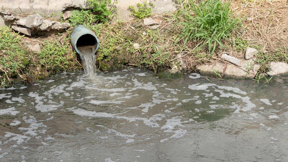 Storm overflow discharging into river