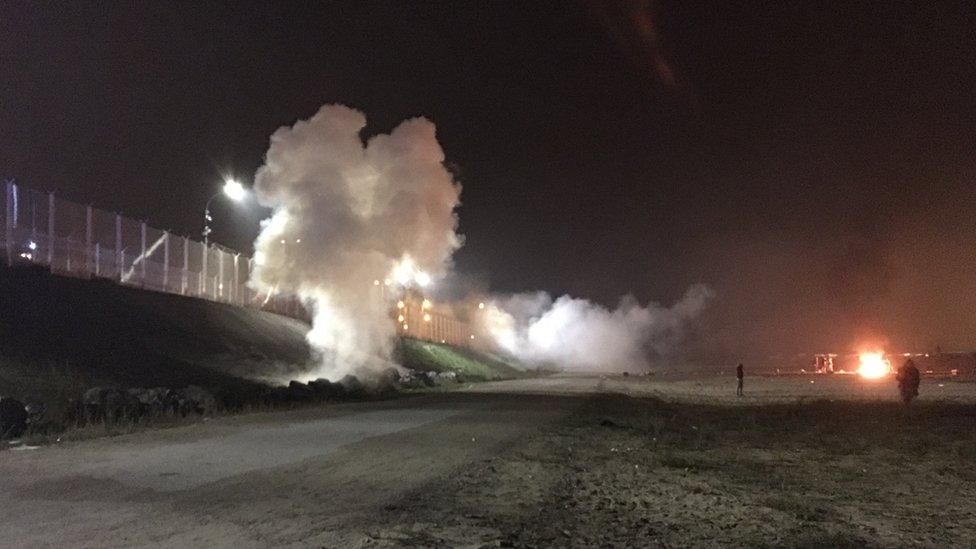 Smoke grenades fired by riot police, between the camp and the road, the night before the Jungle clearance began