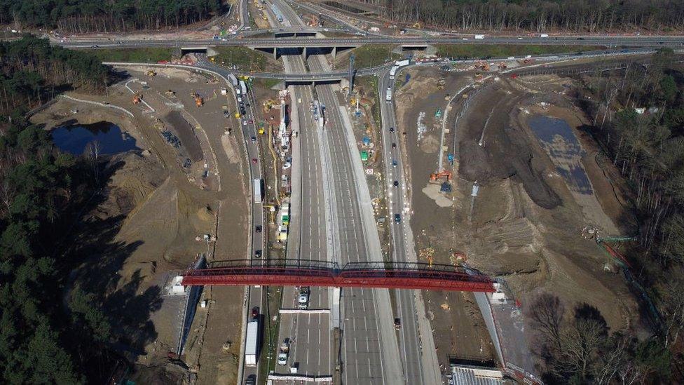 A red metal structure is in place over the closed M25