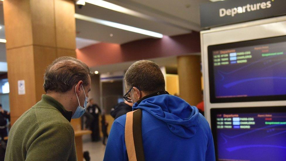 Passengers check tickets at an airport