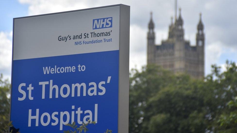 Signs of the NHS are pictured outside St. Thomas' hospital in central London on August 21, 2018.