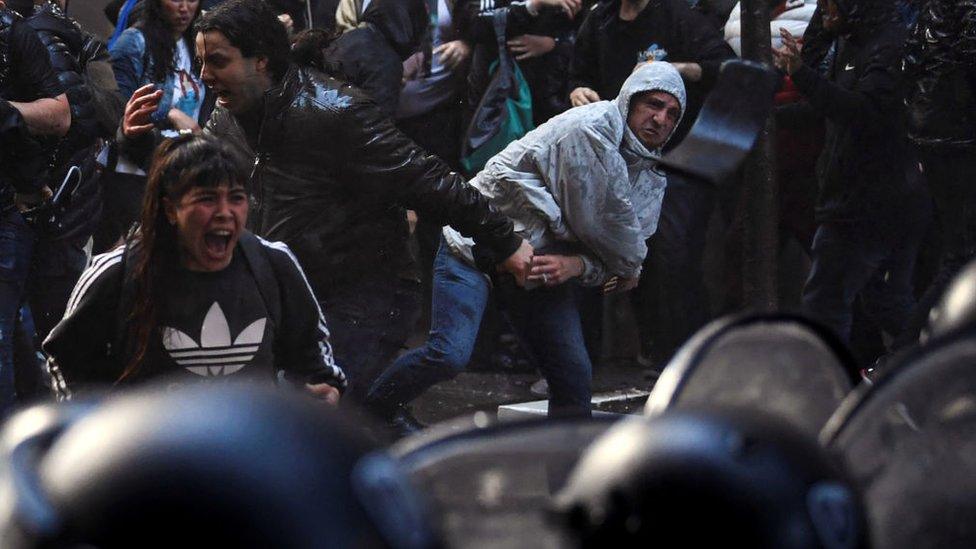 Demonstrators and police outside the home of Argentina's Vice President Cristina Fernandez de Kirchner in Buenos Aires on Saturday