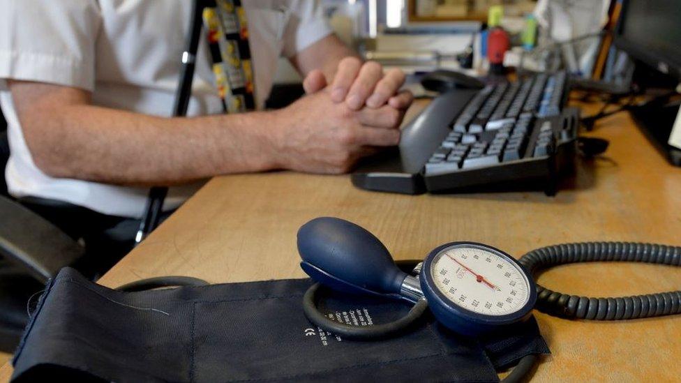 A GP at their desk