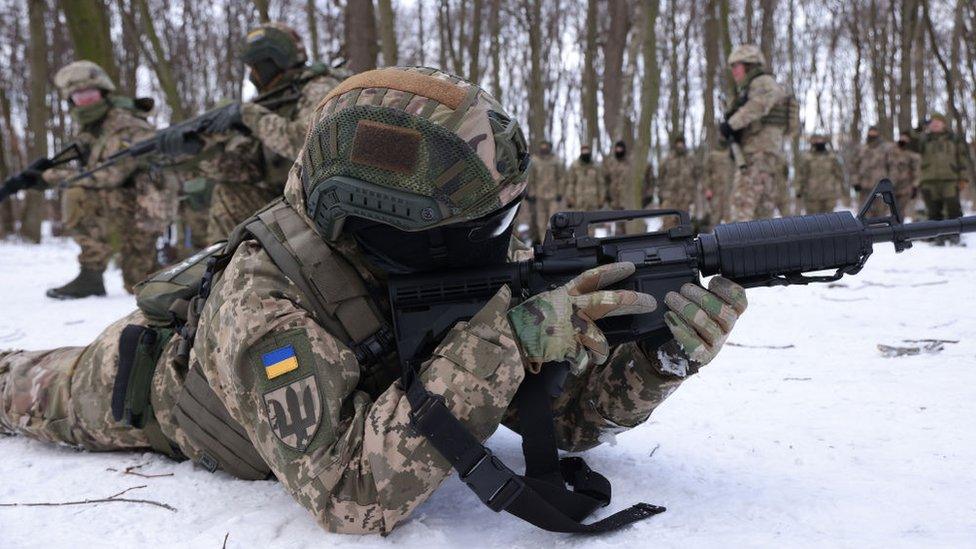 A Ukrainian civilian takes part in a training exercise - Russian forces have been mounting at the border