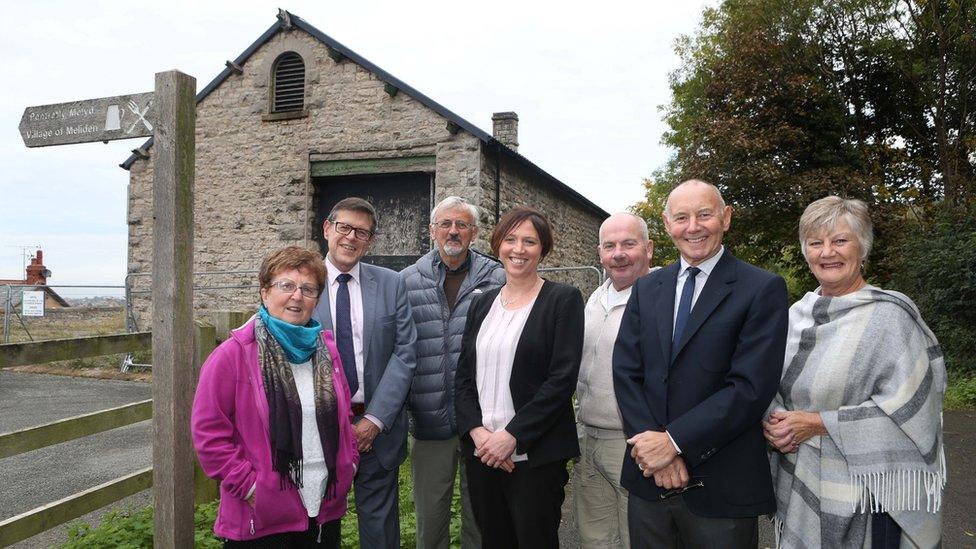 Grwp Cynefin staff and councillors outside the soon to be renovated shed