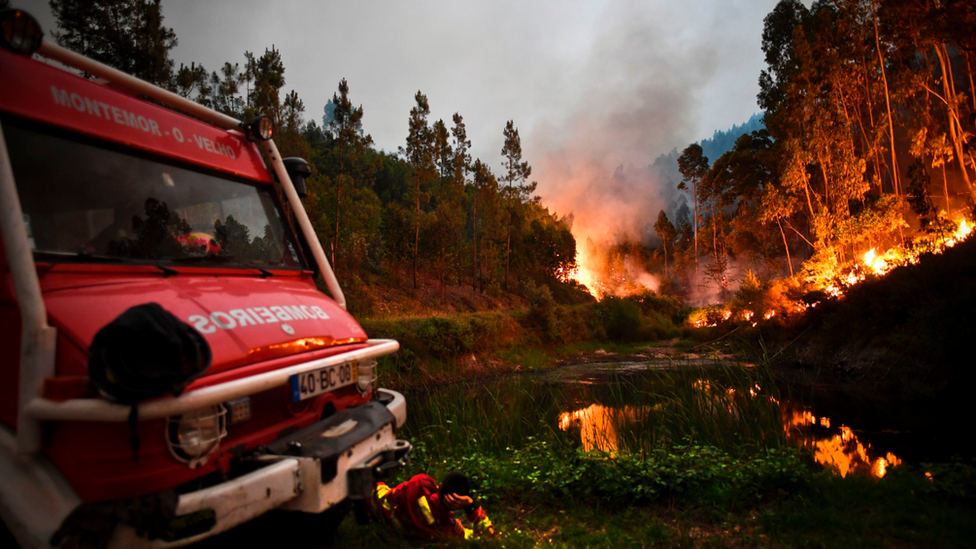 Firefighter resting amid forest fire near Coimbra, June 2017