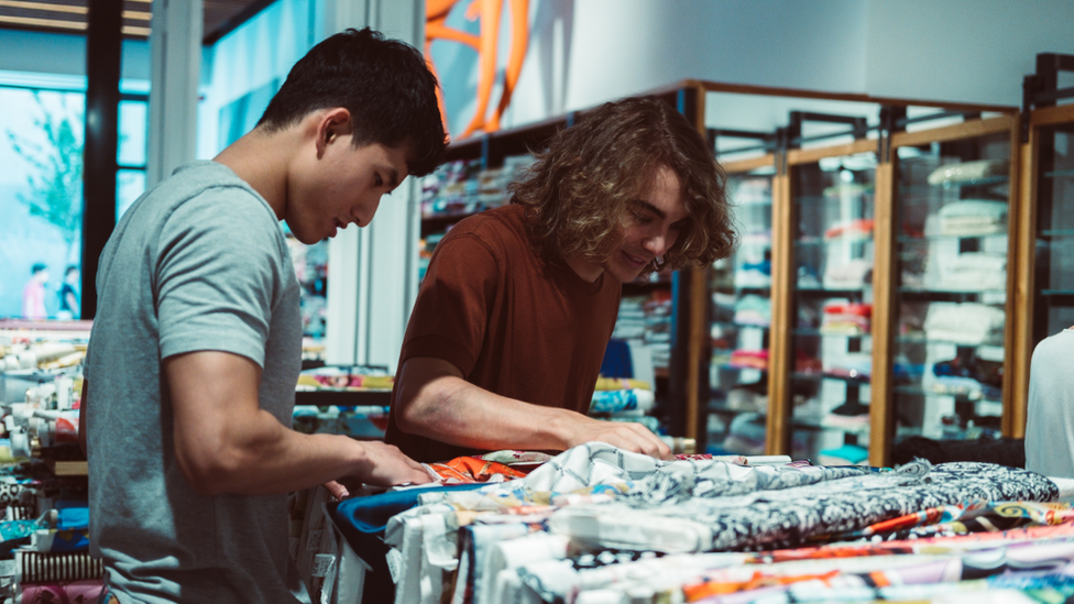 Men browsing clothes in a shop