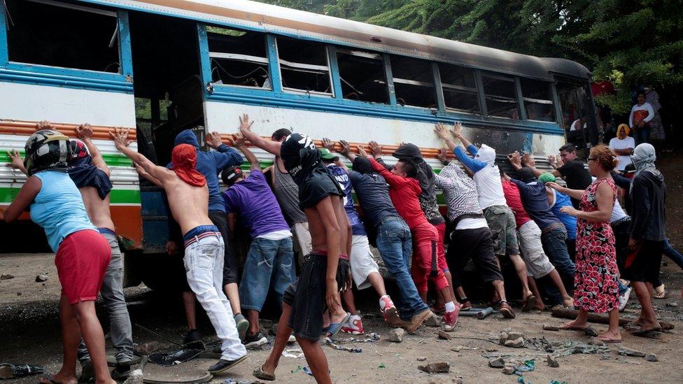 Demonstrators place a burned bus as a barricade during a protest against President Daniel Ortega in Tipitapa, Nicaragua June 14, 2018