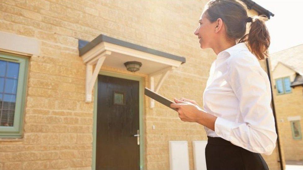 woman looking at house