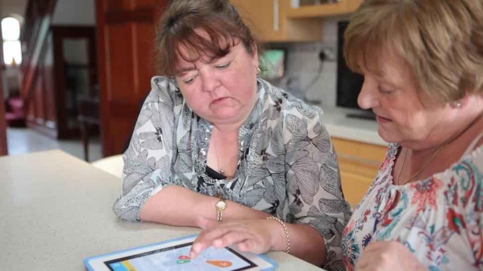 Two women looking at a tablet