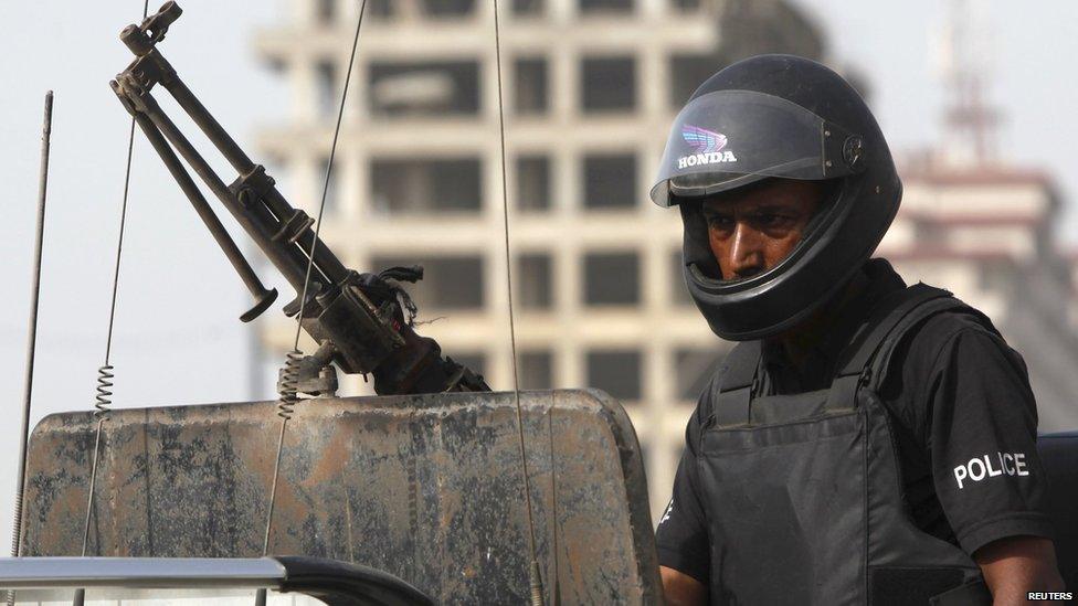 A policeman stands guard in Karachi, Pakistan on 14 May