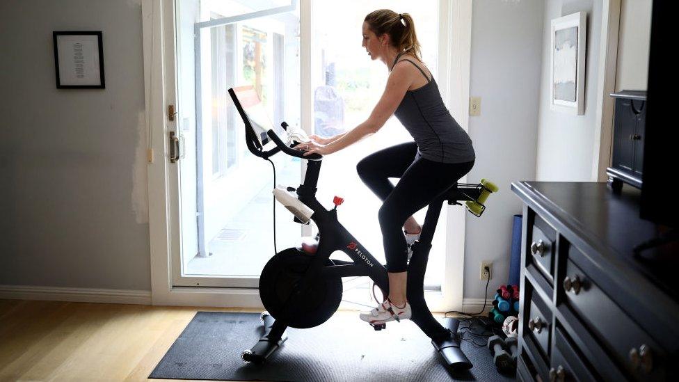 Person on a Peloton exercise bike