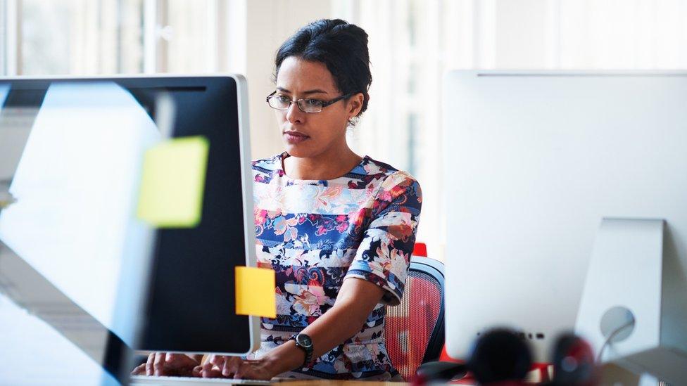 Woman using a computer in an office