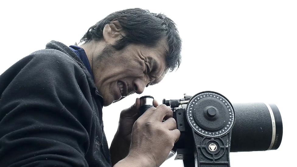 Robert Soolook looks through a telescope