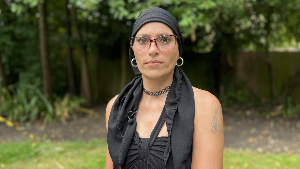 Dayana wearing glasses sitting in the garden