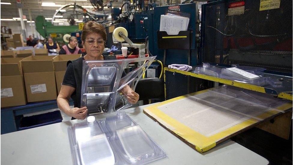 A woman works at a plastic food packaging factory in the US