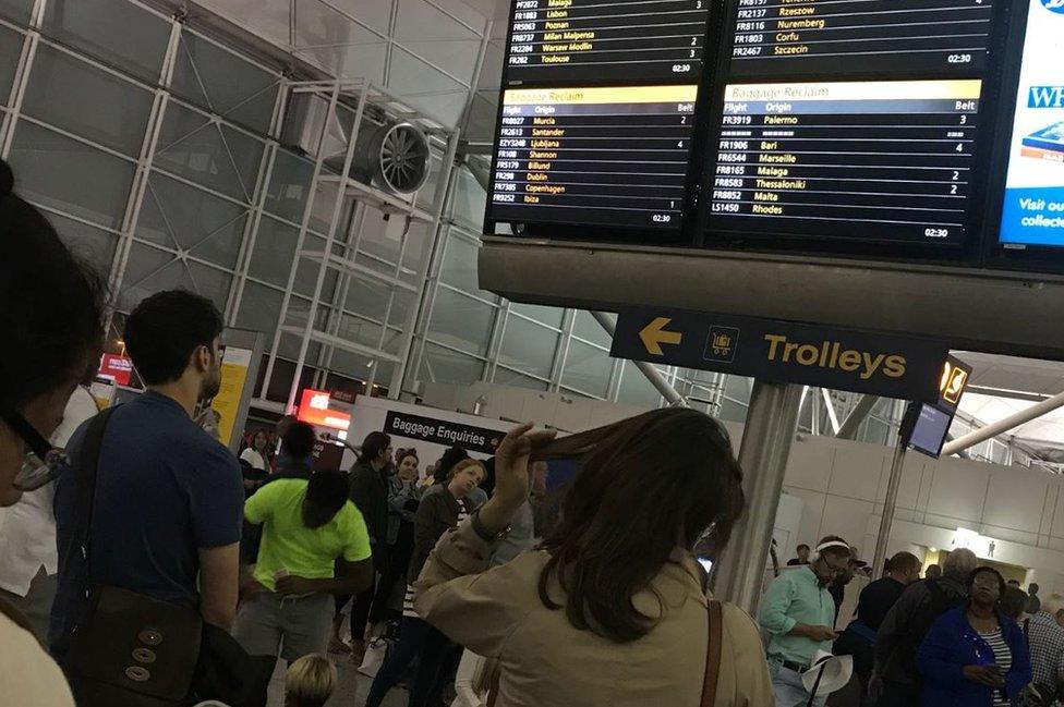 Passengers waiting for baggage at Stansted Airport