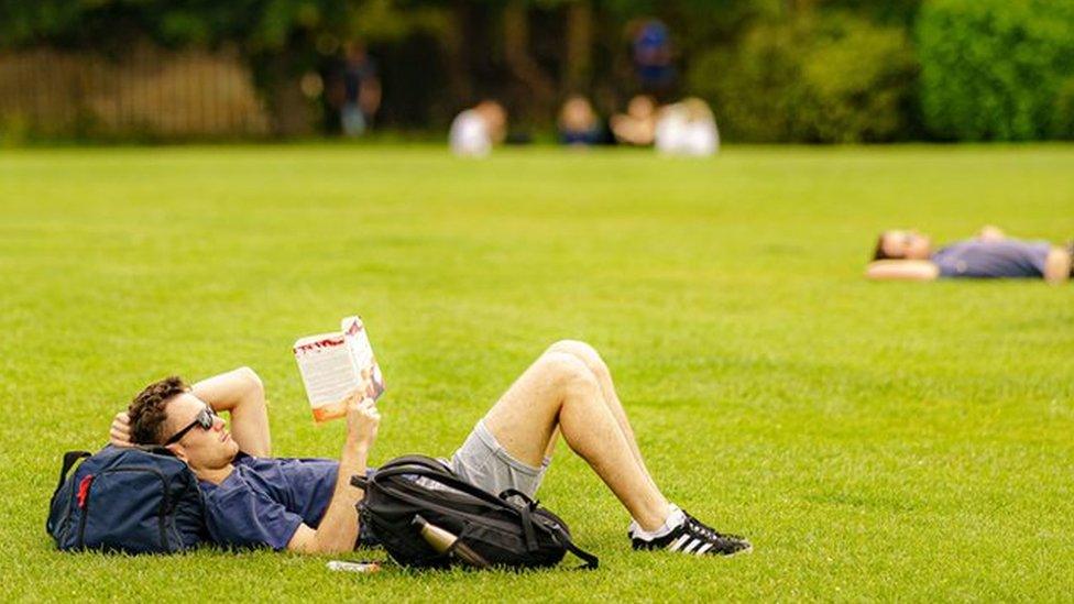 People relax in the sun on the grass at the Royal Crescent, Bath. Picture date: Monday June 13, 2022.