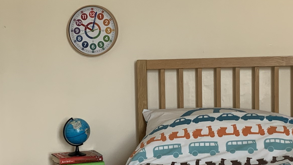 The clock on a child's bedroom wall