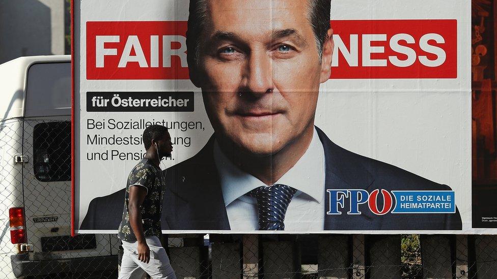 A man walks past an election campaign billboard that shows Heinz-Christian Strache of the far-right Freedom Party