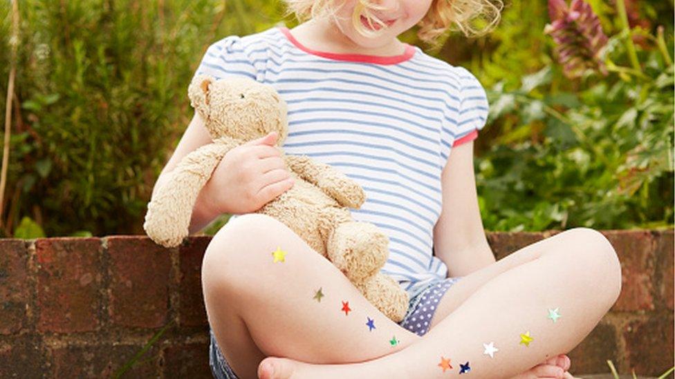 A child holding a teddy bear