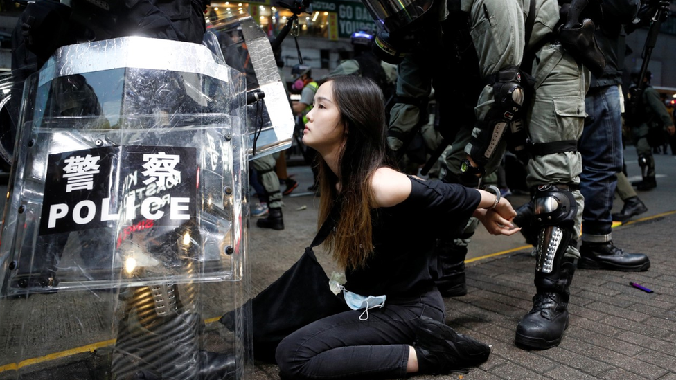 Young woman is arrested police in Hong Kong during protests there