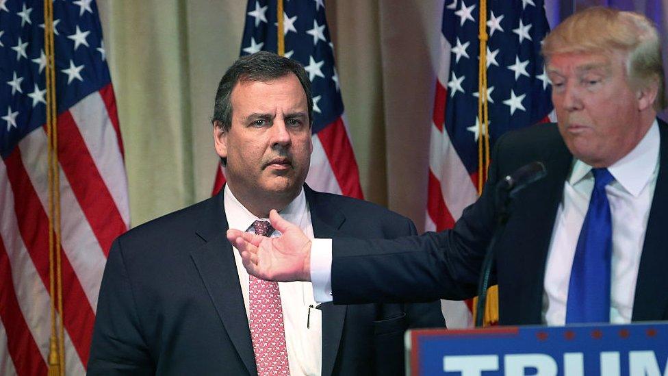 Chris Christie stands next to Donald Trump.