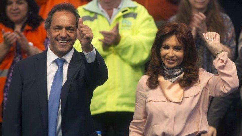 Daniel Scioli and President Cristina Fernandez de Kirchner wave to their supporters during a rally in Buenos Aires on 5 October, 2015