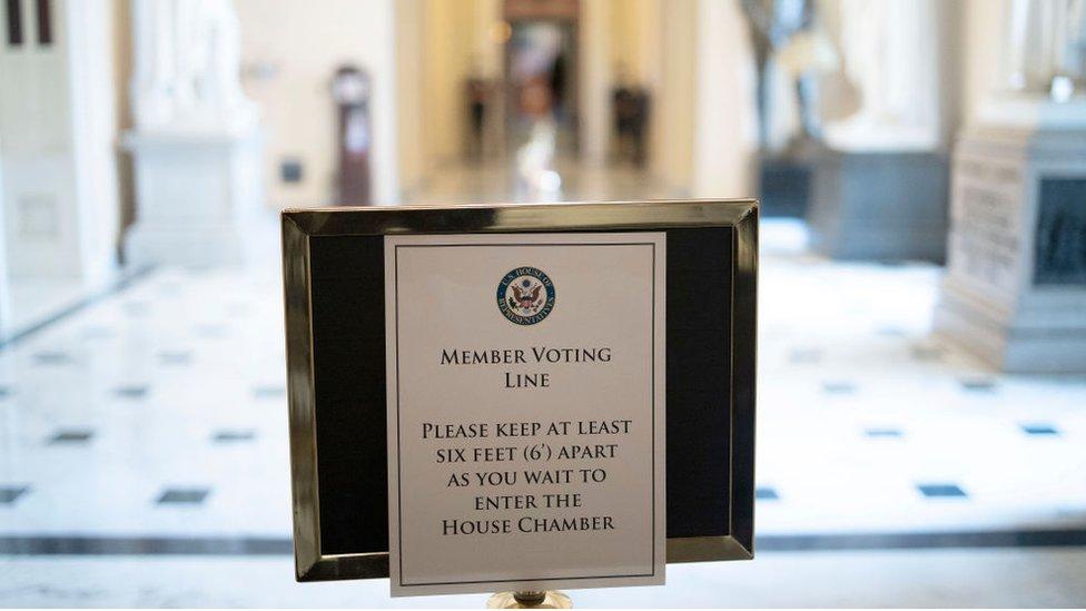 A sign in Congress mandates social distancing for lawmakers