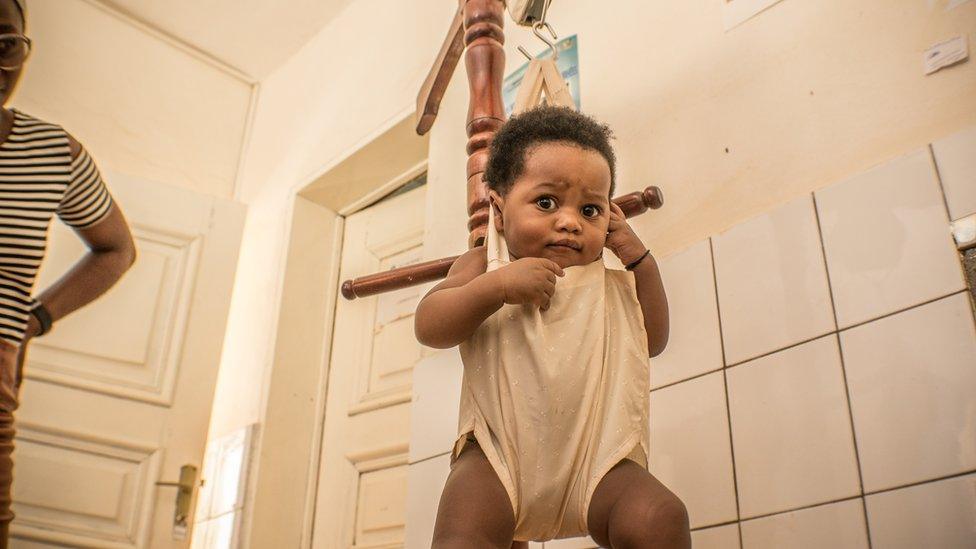 A baby being weighed