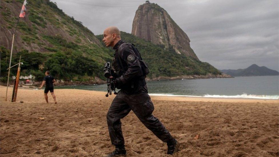 A member of the military police, patrols during a police operation in Vermelha beach at Urca neighbourhood, Rio de Janeiro, Brazil, on June 8, 2018